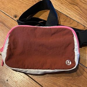 lululemon athletica rust red and pink waist pack with cream trim